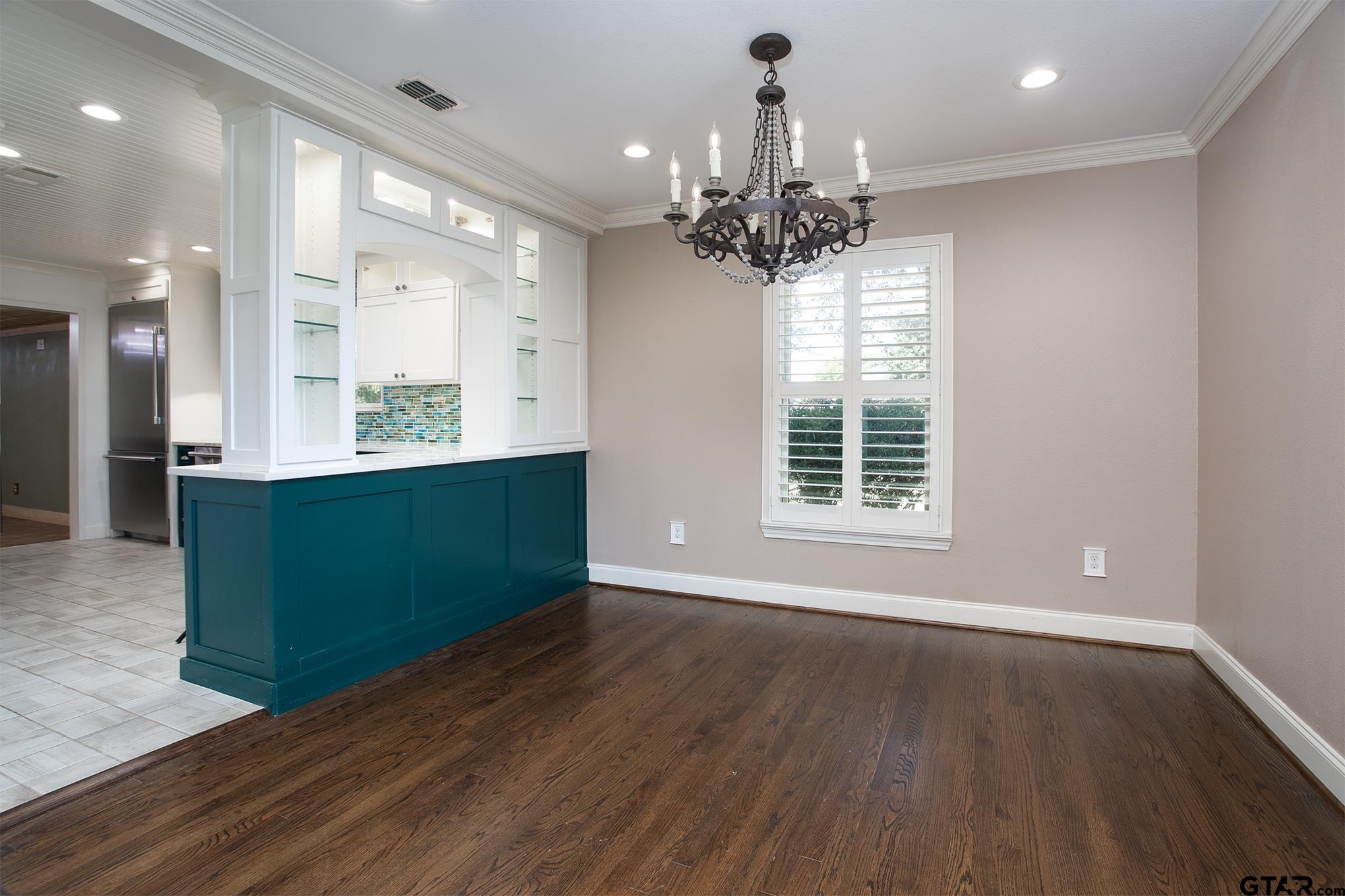 502 West Hubbard Street Lindale, TX 75771 - Photo 14 of 48 wooden floor in an empty room with a window