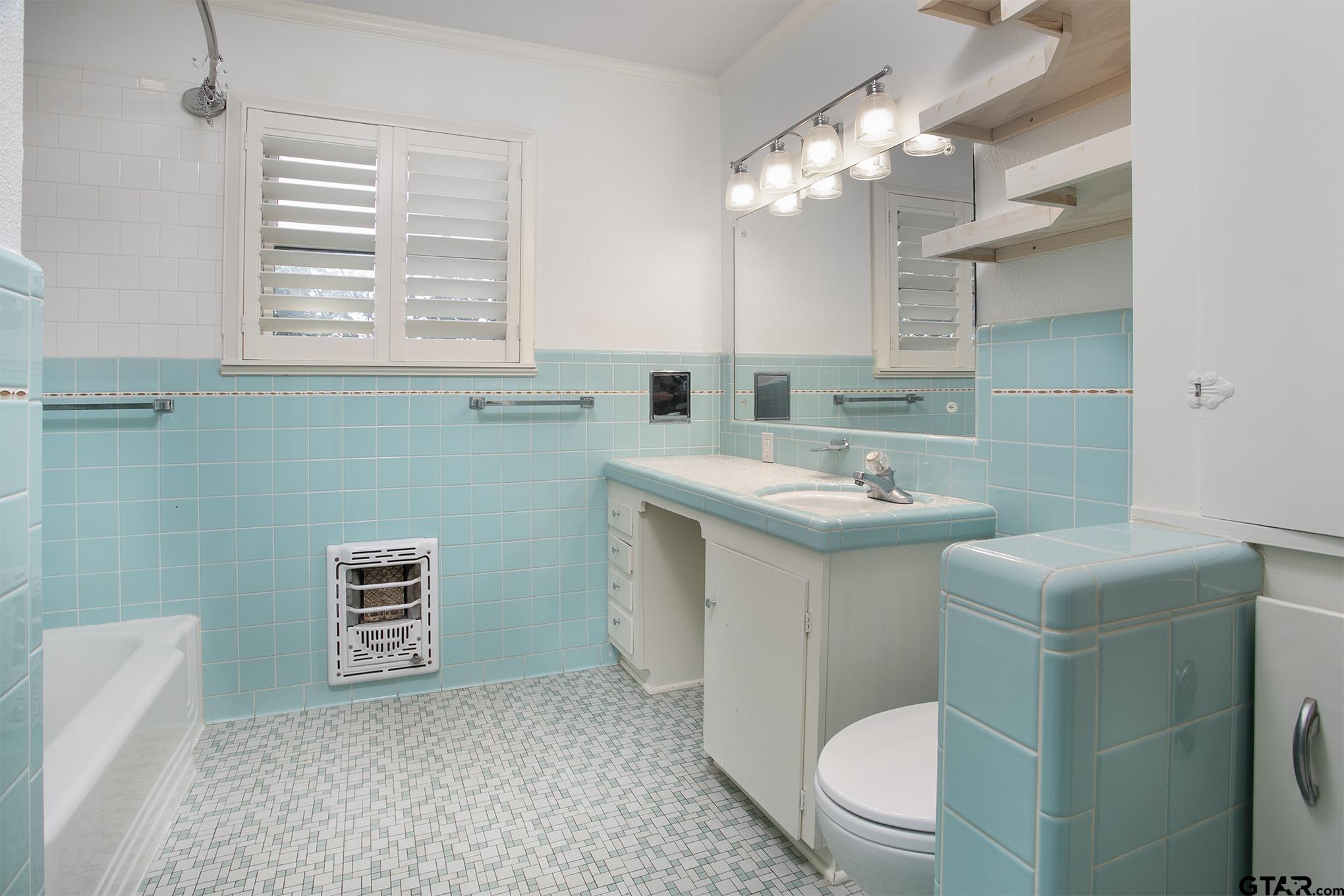 502 West Hubbard Street Lindale, TX 75771 - Photo 20 of 48 a bathroom with a sink a toilet and mirror