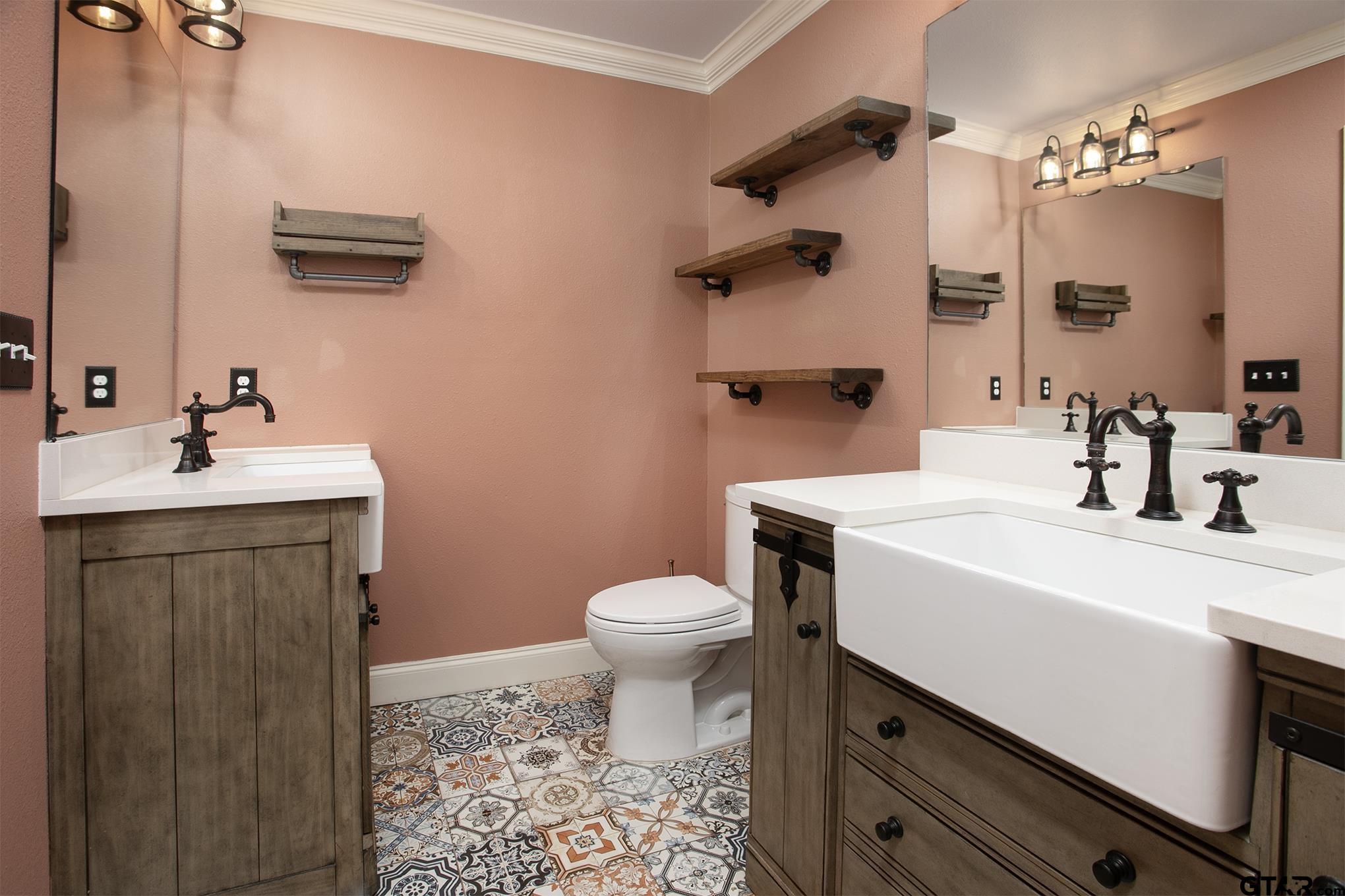 502 West Hubbard Street Lindale, TX 75771 - Photo 27 of 48 a bathroom with a sink a toilet and mirror