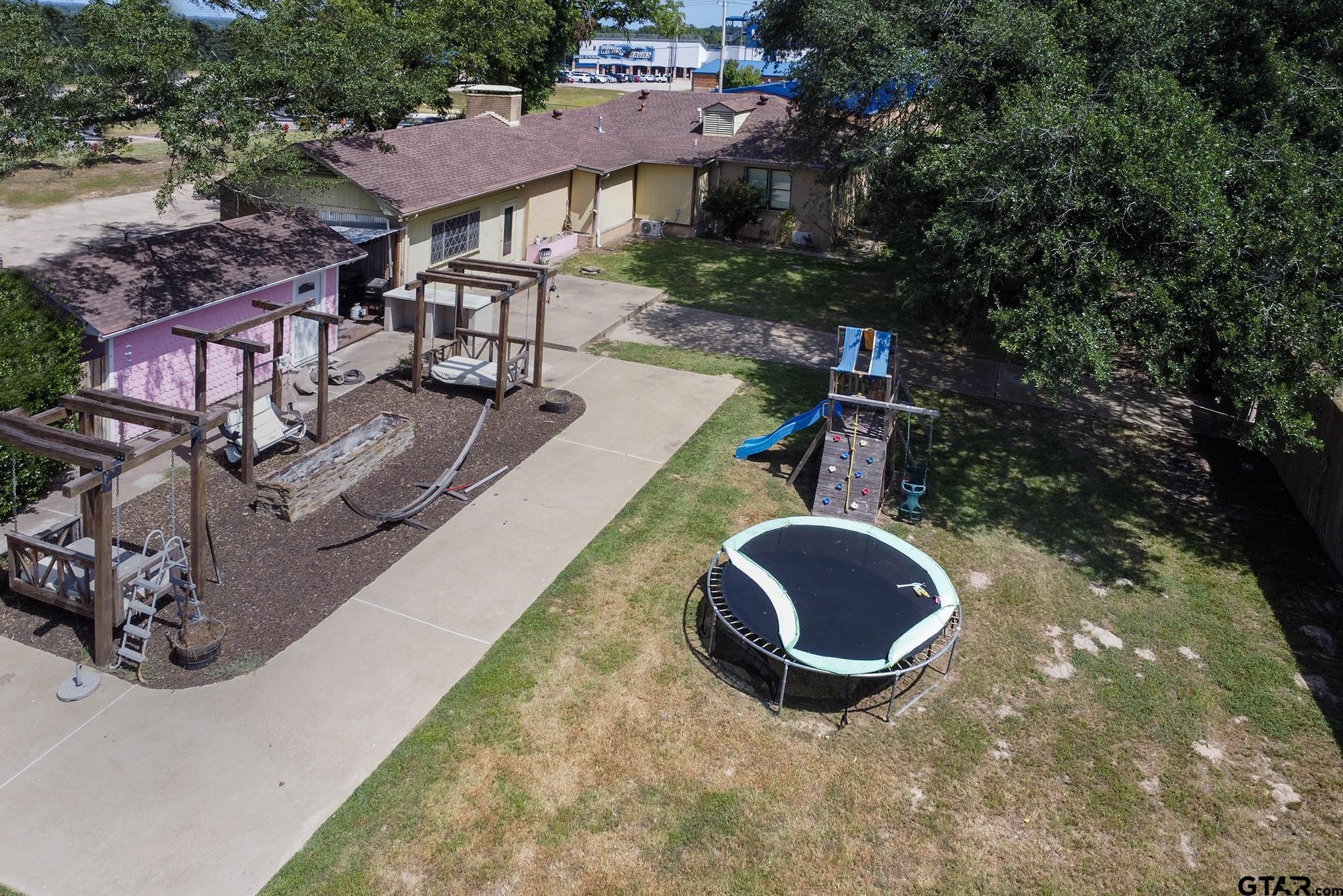 502 West Hubbard Street Lindale, TX 75771 - Photo 34 of 48 an aerial view of a house with garden space and street view