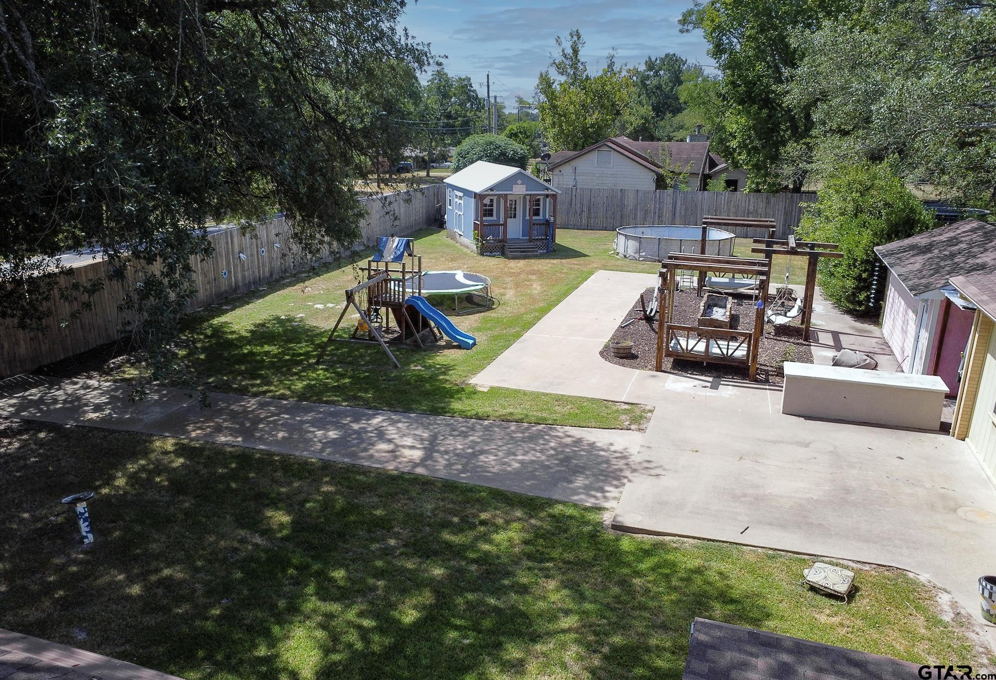502 West Hubbard Street Lindale, TX 75771 - Photo 37 of 48 a view of a house with backyard and sitting area