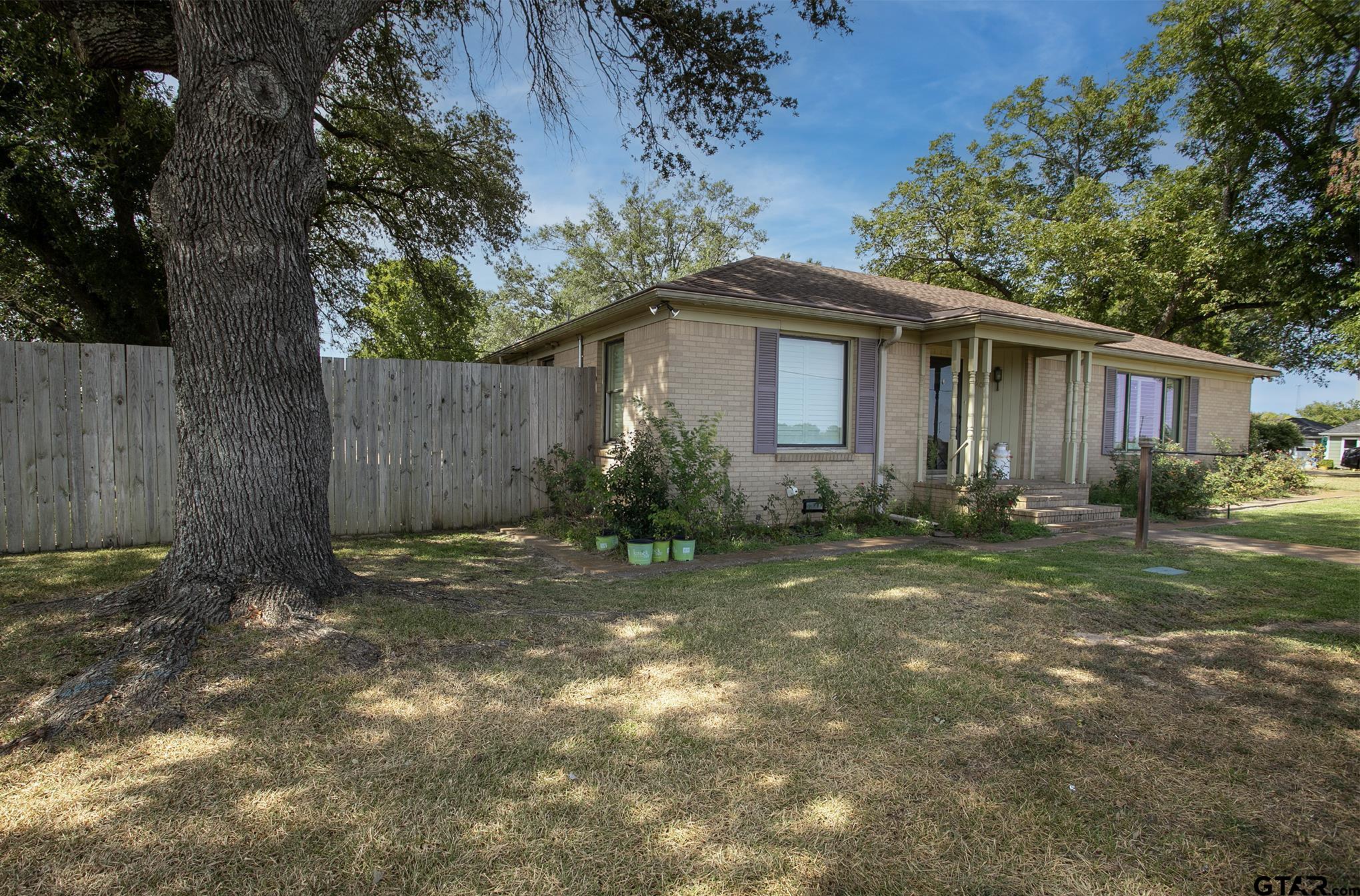 502 West Hubbard Street Lindale, TX 75771 - Photo 43 of 48 a white house that has a tree in front of it