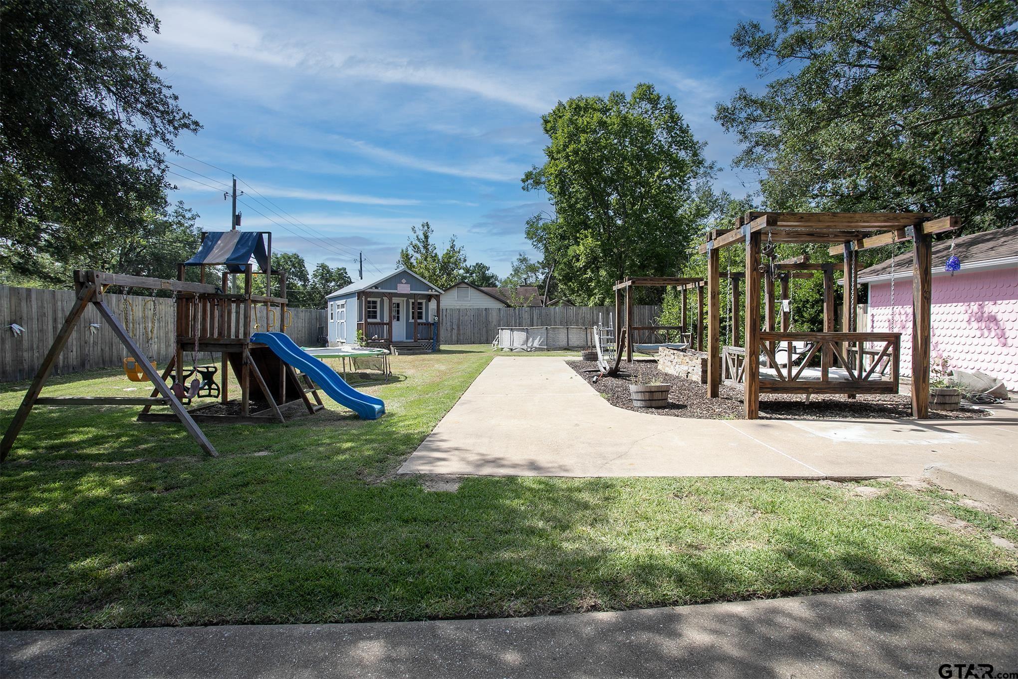 502 West Hubbard Street Lindale, TX 75771 - Photo 44 of 48 a view of a park with swings