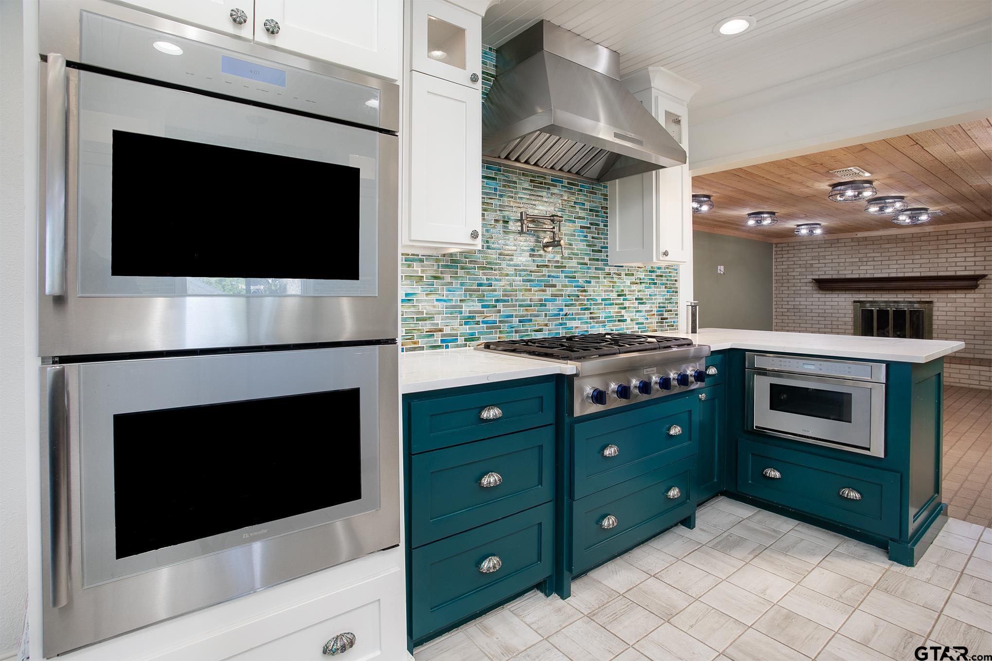 502 West Hubbard Street Lindale, TX 75771 - Photo 5 of 48 a kitchen with a stove and a microwave
