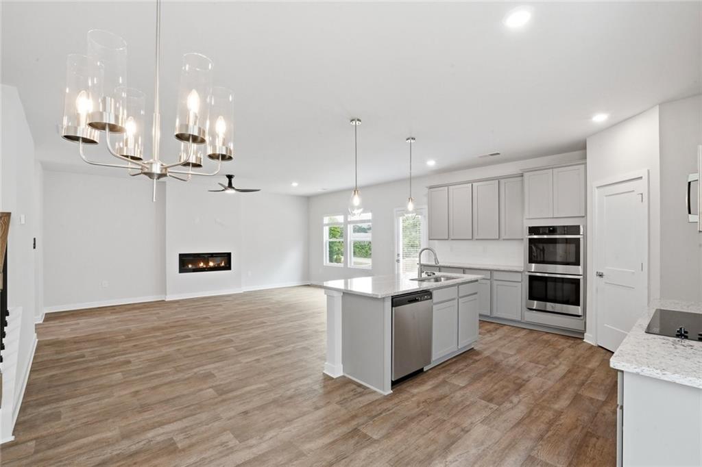 5351 Tolar Road South Fulton, GA 30213 - Photo 9 of 30 a kitchen with stainless steel appliances kitchen island granite countertop a refrigerator a stove a oven and white cabinets with wooden floor
