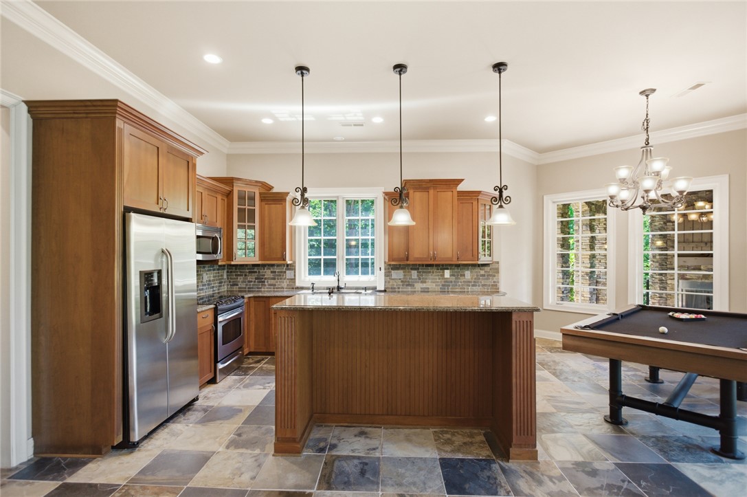 130 River Ridge Road Sunset, SC 29685 - Photo 26 of 47 A well-appointed kitchen features stainless steel appliances, a center island, and natural stone flooring.