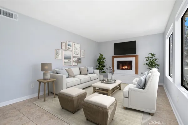 a living room with furniture a fireplace and a flat screen tv