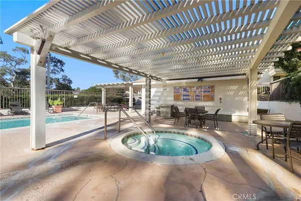 a view of a swimming pool with outdoor seating