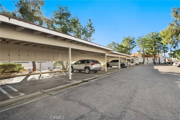 a couple of cars parked in parking area of a building