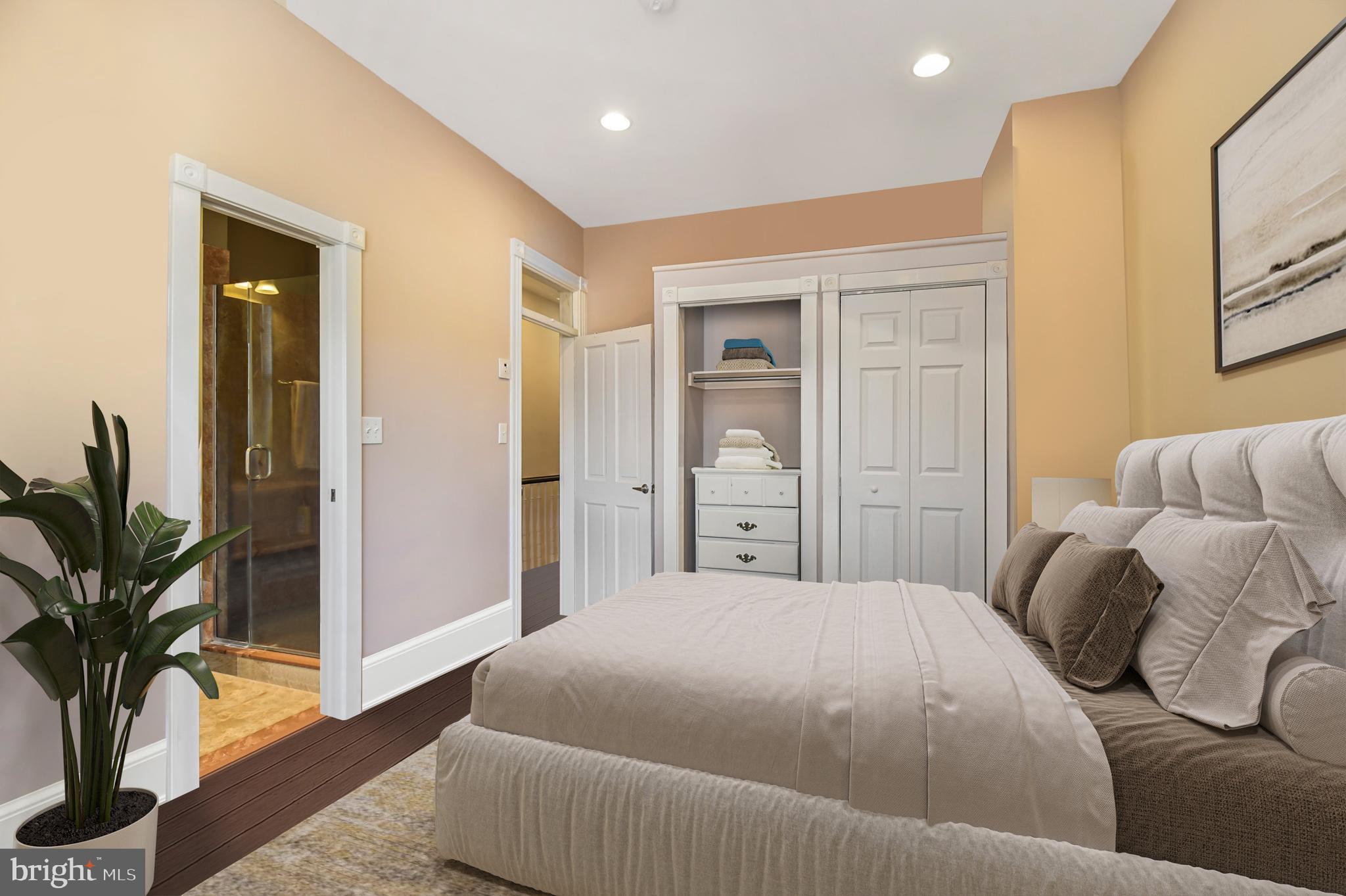 1330 35th Street Northwest Washington, DC 20007 - Photo 16 of 30 a bedroom with a large bed and a potted plant
