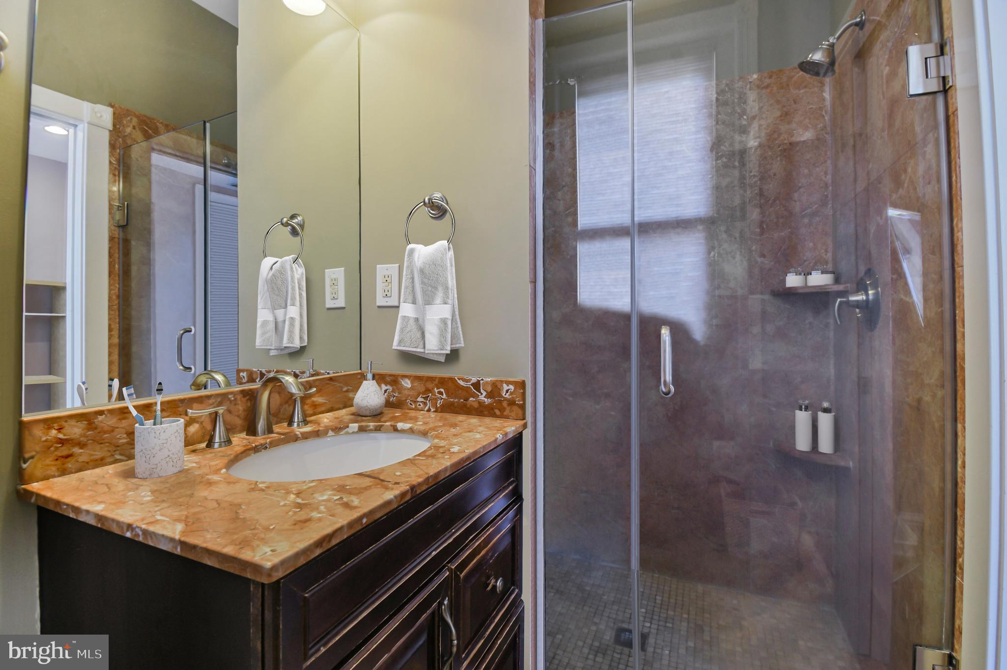 1330 35th Street Northwest Washington, DC 20007 - Photo 17 of 30 a bathroom with a granite countertop sink and a mirror
