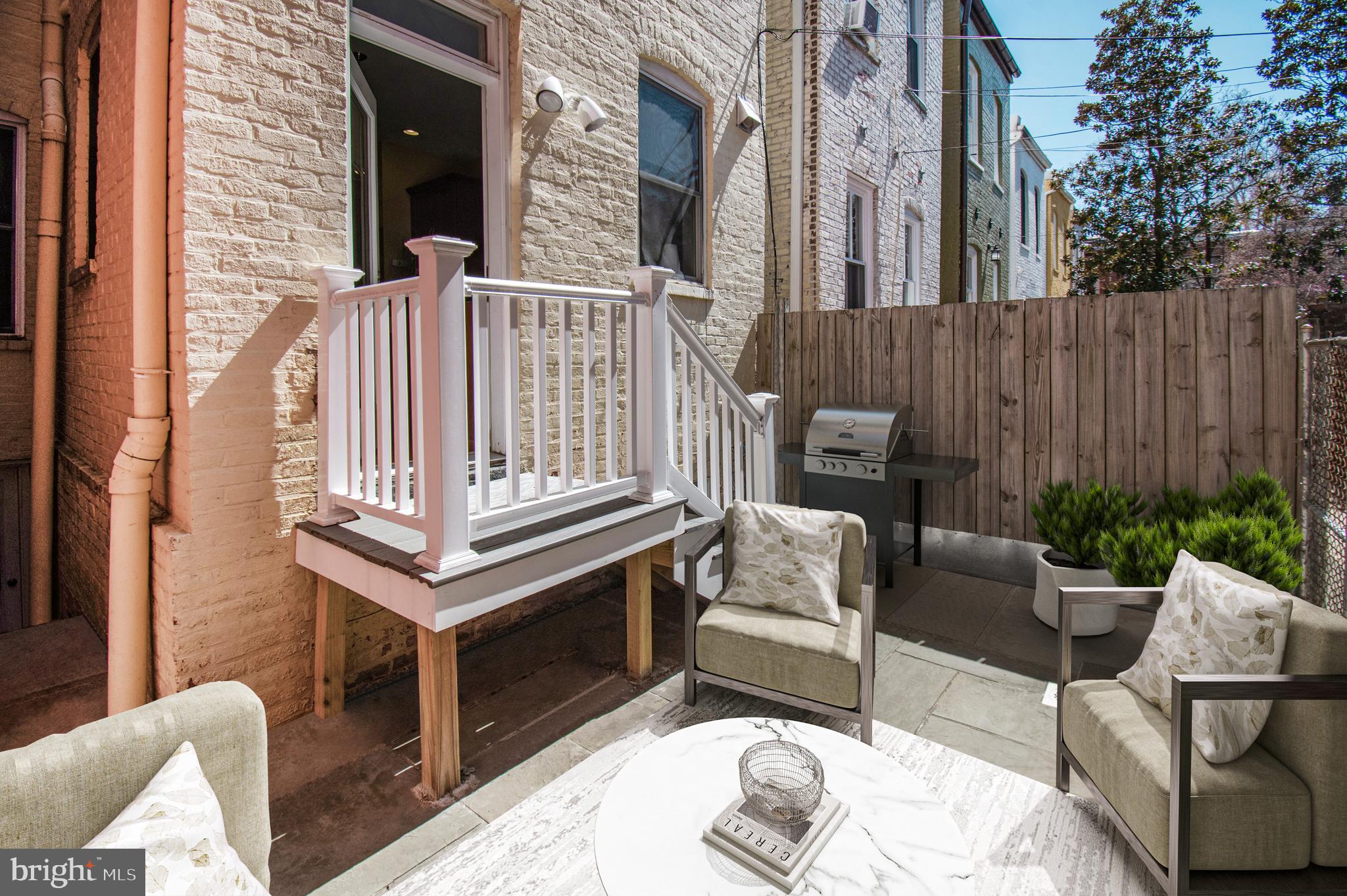 1330 35th Street Northwest Washington, DC 20007 - Photo 30 of 30 a view of a patio with couches chairs and a fireplace