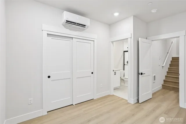 a view of a hallway with wooden floor and entryway