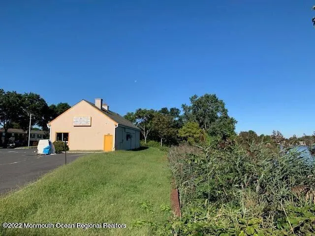 a front view of a house with glass windows and a table and chairs