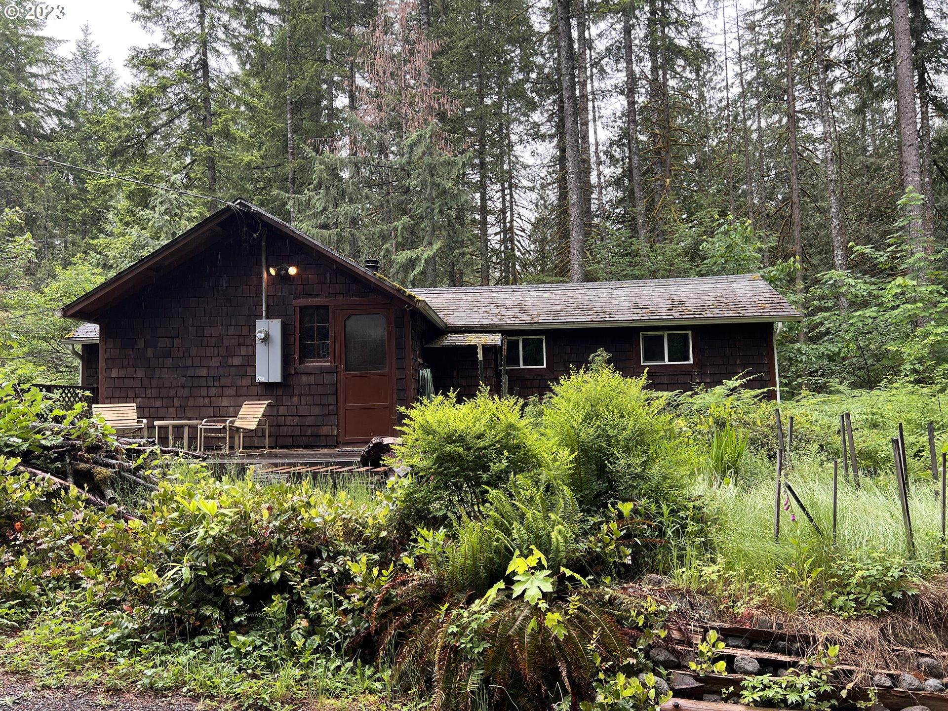 69946 Rhododendron Lane Rhododendron, OR 97049 - Photo 2 of 14 a front view of a house with a yard