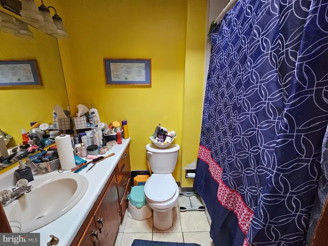 a bathroom with a sink mirror vanity and toilet