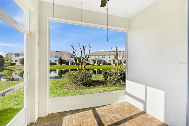 a view of a livingroom with a ceiling fan and window
