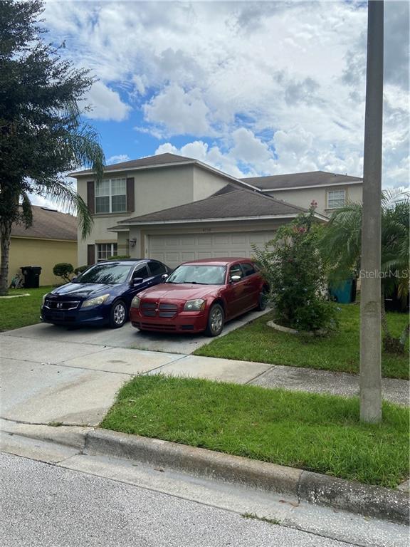 a couple of cars parked in front of a house