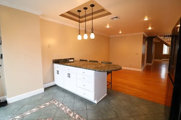 a kitchen with stainless steel appliances granite countertop a sink a stove and a refrigerator