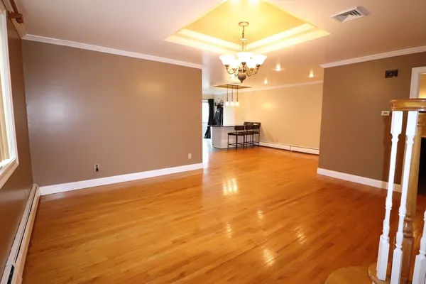en view of a livingroom with a furniture a chandelier