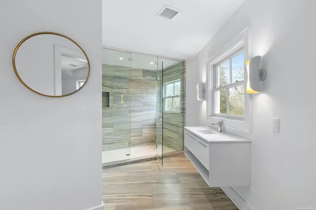 a bathroom with a double vanity sink and a mirror