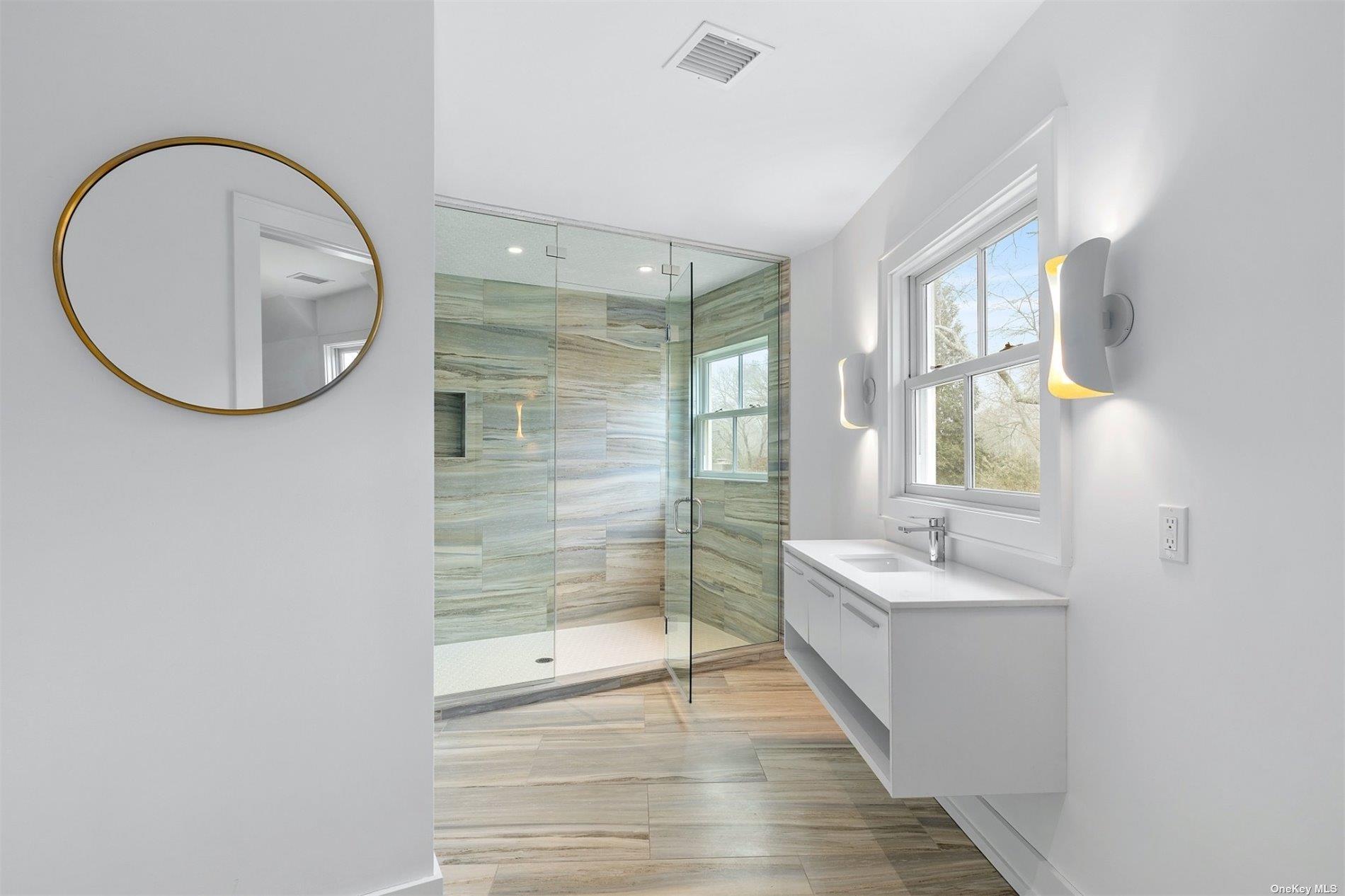 81 Skimhampton Road East Hampton, NY 11937 - Photo 11 of 24 a bathroom with a double vanity sink and a mirror