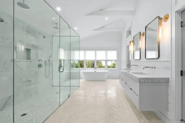 a bathroom with a granite countertop sink mirror and shower