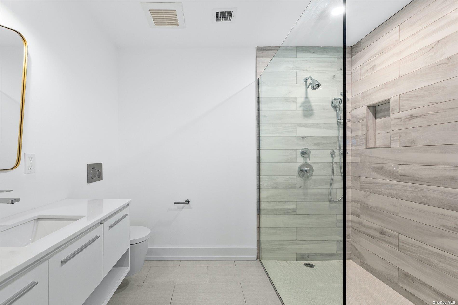 81 Skimhampton Road East Hampton, NY 11937 - Photo 16 of 24 a bathroom with a granite countertop sink a shower and mirror
