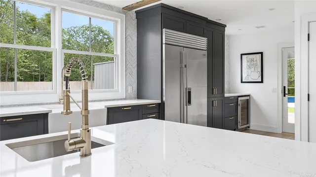 a kitchen with a stove a refrigerator and a sink