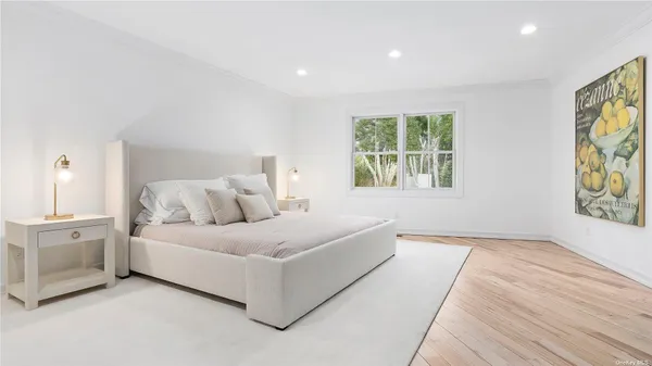 a spacious bedroom with a large bed and a window