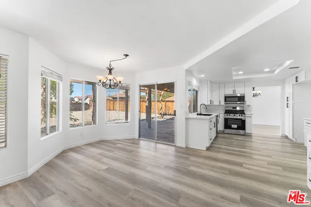 a view of kitchen with furniture and wooden floor