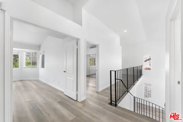 a view of a hallway with wooden floor and entryway