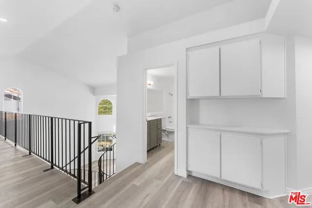 a view of a hallway with wooden floor and entryway