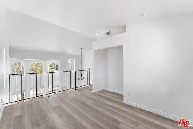 a view of a room with wooden floor