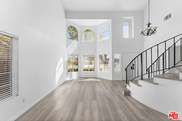 a view of an entryway with wooden floor