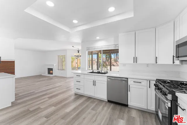 a kitchen with stainless steel appliances granite countertop a stove and a sink