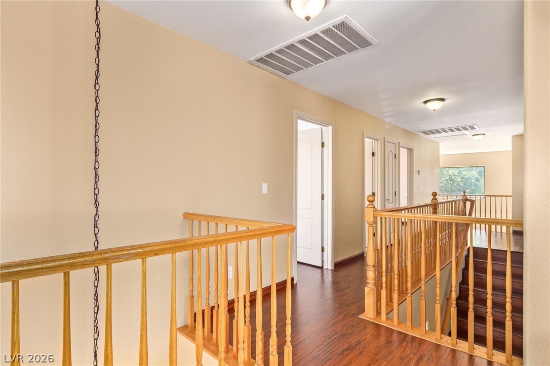 1477 Rancho Ridge Drive Henderson, NV 89012 - Photo 26 of 46 Rich hardwood flooring leads the way up the well-crafted staircase to a spacious upper-level landing.