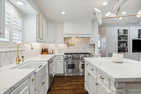 a kitchen with a stove a sink and a refrigerator