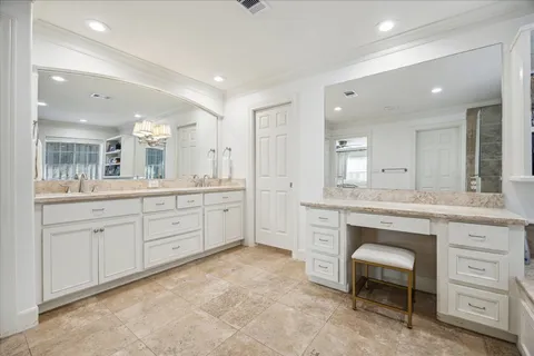 a spacious bathroom with a granite countertop sink a mirror and a vanity