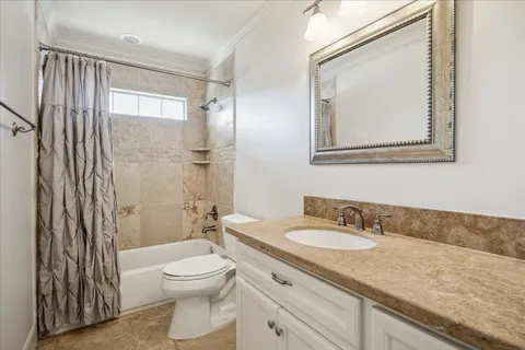 a bathroom with a granite countertop sink toilet a mirror and shower