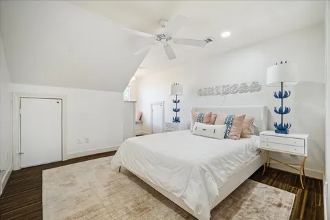 a bedroom with a large bed and a chandelier