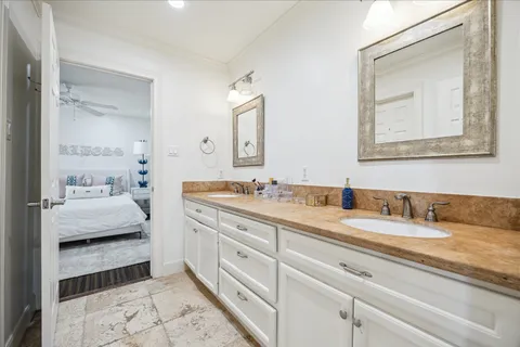 a en suite bathroom with double sink and a mirror
