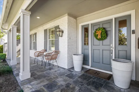 a view of a porch with a table and chairs