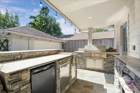 a kitchen with stainless steel appliances granite countertop a sink stove and cabinets
