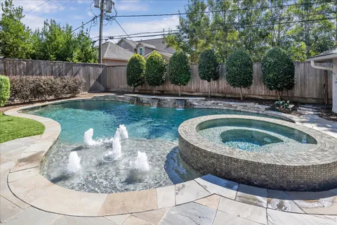 a view of a swimming pool with a yard