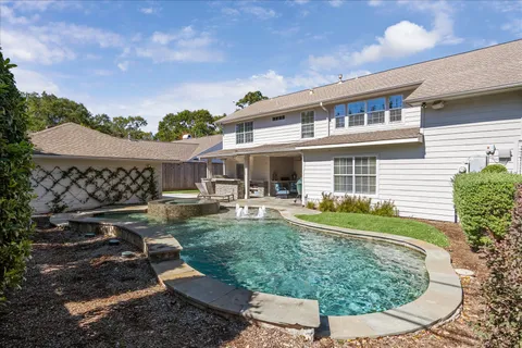 a view of a house with backyard sitting area and garden