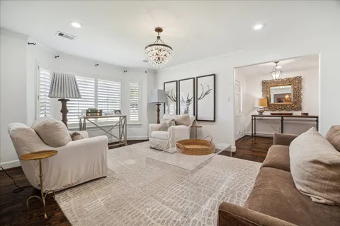 a bedroom with furniture and a large window