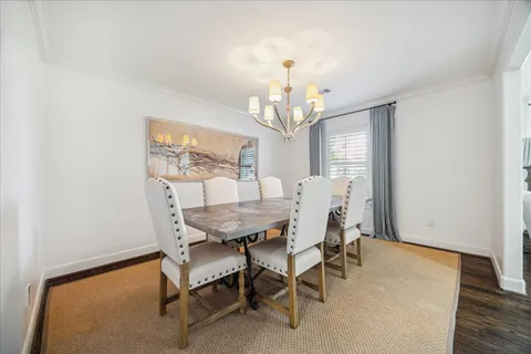 a view of a dining room with furniture and a chandelier