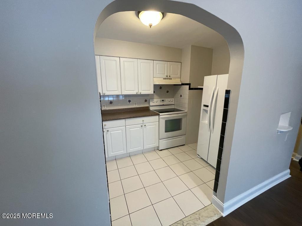 286 Cleveland Avenue, Unit 1 Long Branch, NJ 07740 - Photo 2 of 10 a kitchen with stainless steel appliances a refrigerator sink and microwave
