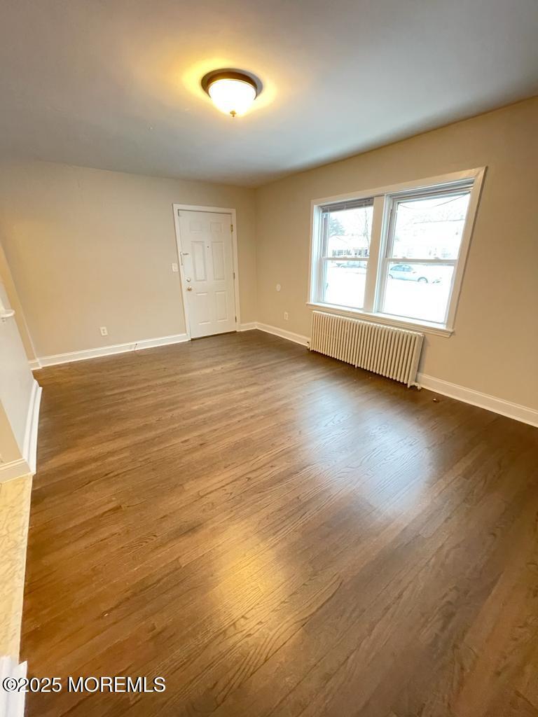 286 Cleveland Avenue, Unit 1 Long Branch, NJ 07740 - Photo 3 of 10 an empty room with wooden floor and windows